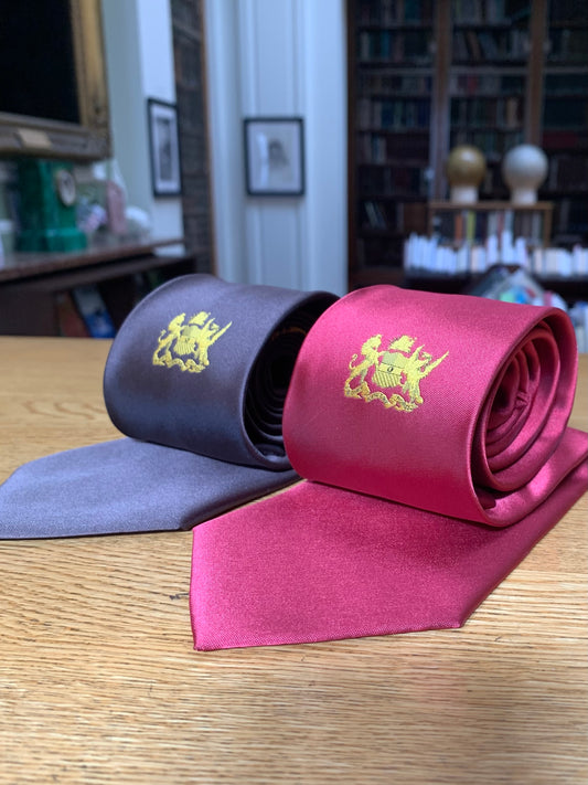 Ties embroidered with the Linnean Society of London crest in gold, one red and one dark brown