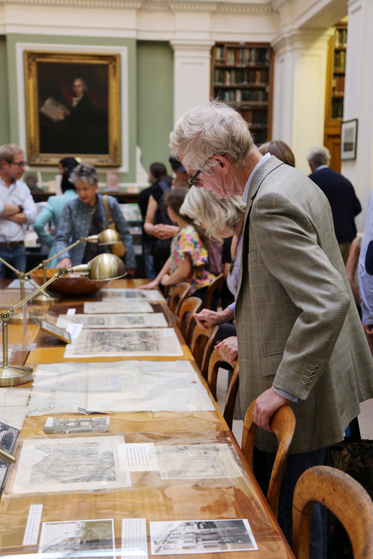 Visitors looking at a variety of printed materials on a tour at the Linnean Society in London